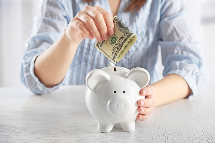 woman saving money in a piggy bank